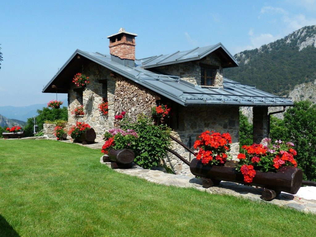 Holiday House with large red geraniums